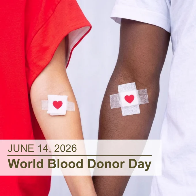 Close-up of two people’s arms, extended down, each with a taped piece of gauze with a red heart on it, indicating a blood draw area; the woman on the left is wearing a red t-shirt and the man on the right is wearing a white t-shirt; the superimposed text at the bottom left reads “June 14, 2026, World Blood Donor Day”