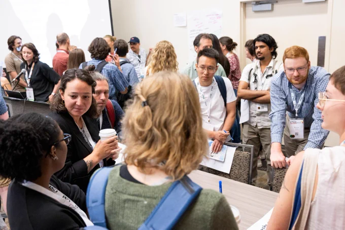 Early career ecologists network following scientific presentations at an ESA event