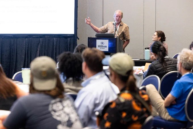 A senior ecologist presents research in front of a full room at an ESA event