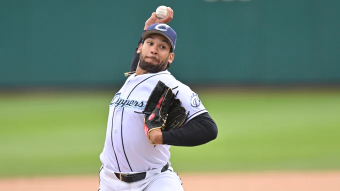 An image of Daniel Espino in a white Columbus Clippers jersey with a blue cap