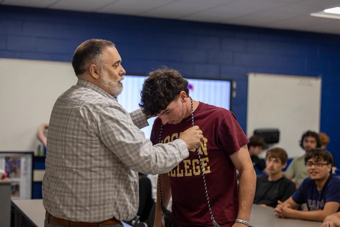 Students receiving cords