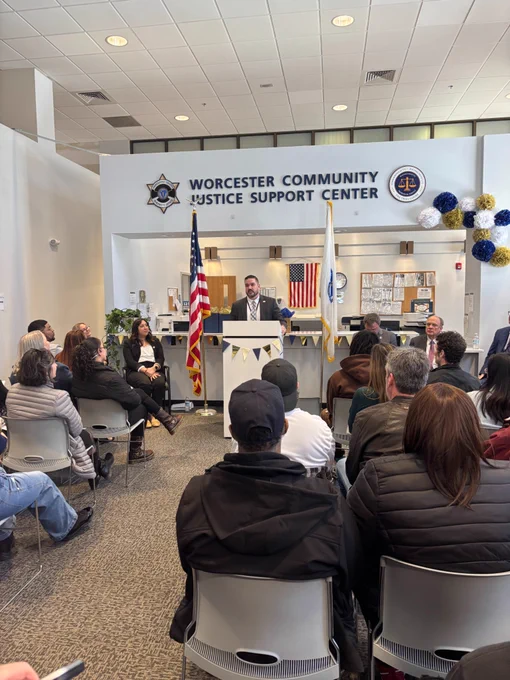 A speaker addresses attendees during a ceremony at the Worcester Community Justice Support Center.