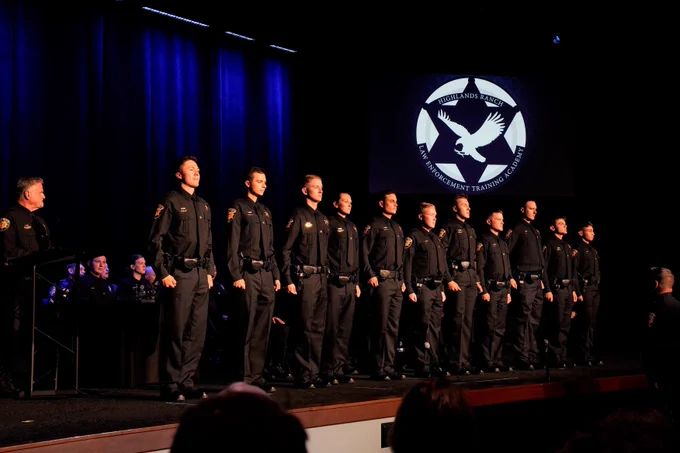 Deputies standing at attention on stage