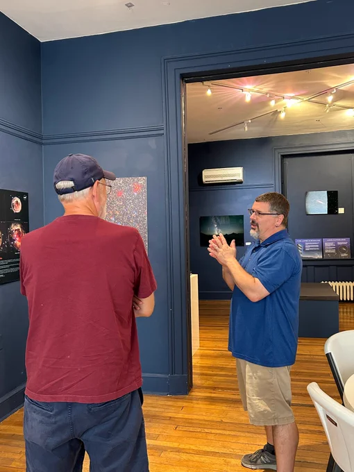 Chris Palma talking to someone at the Bellefonte Art Museum special astronomy exhibit.
