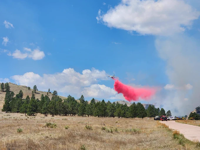 South Fork Fire, Nebraska. Photo from InciWeb. An airtanker drops retardant near a wildfire burning in grass and timber. 