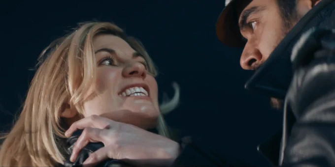 the doctor (whittaker), a feral expression on her face, making eye contact with the master (dhawan), and holding onto the hand he's using to choke her. 

from spyfall part two 