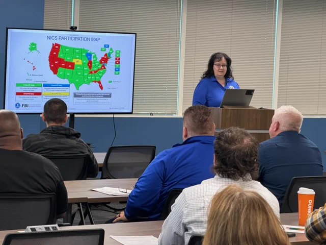 FBI employee engages with representatives from federal firearms licensees during recent National Instant Criminal Background Check System (NICS) Retailer Days. 