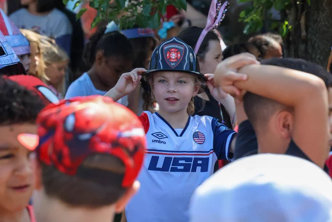 Students wears Irondequoit fire department helmet and USA jerset