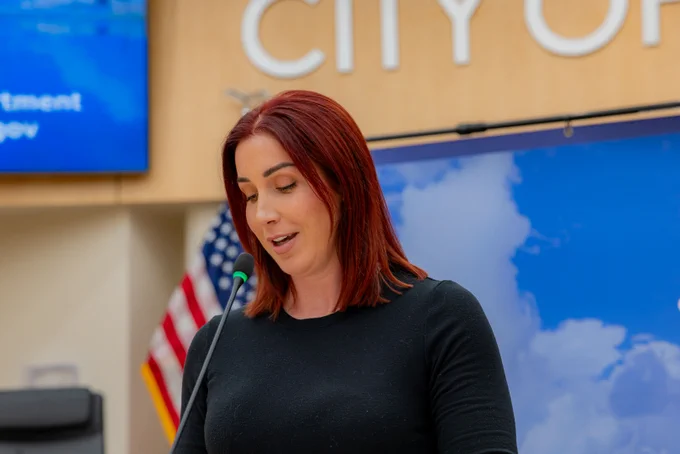 Ashley Marion, Strategic Business Manager of Corpus Christi Water, speaks at a podium inside the City Council Chambers at Corpus Christi City Hall.