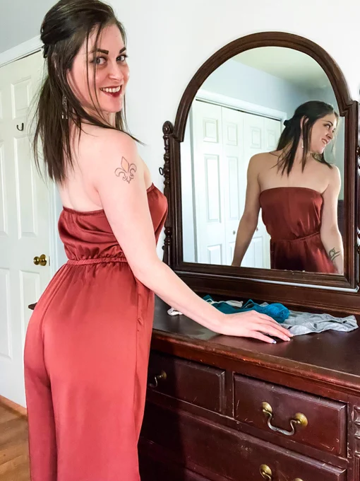 a blue-eyed brunette standing in front of her dresser