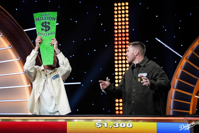 A photo of Miguel Rojas holding up the $1 million sign on Wheel of Fortune.