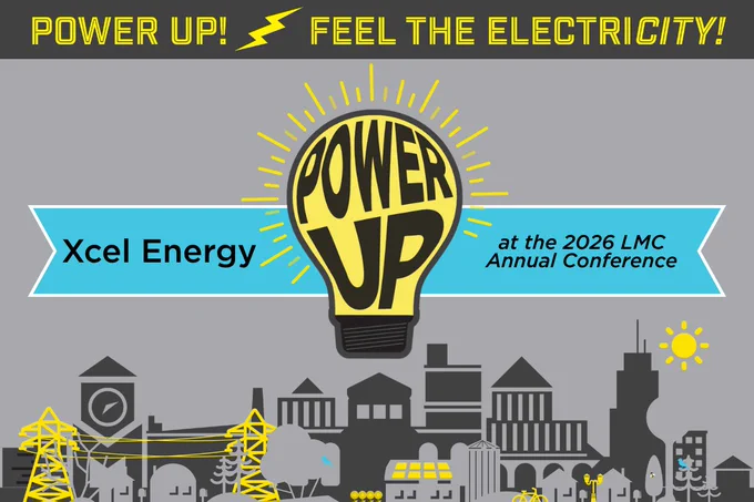 Yellow light bulb with 'POWER UP' text glowing above a cityscape, promoting Xcel Energy at the 2026 LMC Annual Conference.
