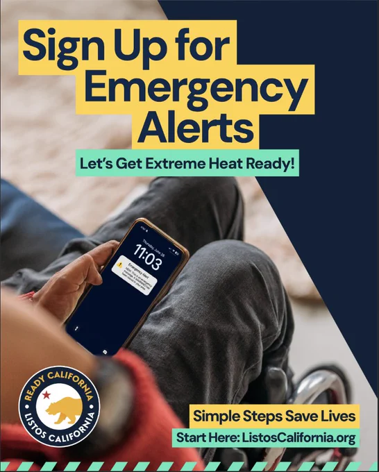 A person in a wheelchair holding a smartphone displaying an alert message. Text reads "Sign Up for Emergency Alerts" and "Let's Get Extreme Heat Ready!" The Ready California logo is visible, along with a prompt to visit ListosCalifornia.org for more information.