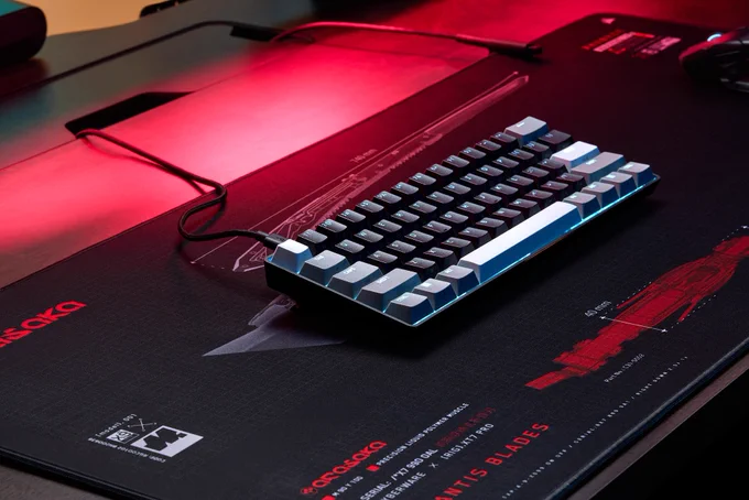An image of a black CLIPPER PRO MINI 60 keyboard.  It is on a black and red mouse mat. 
