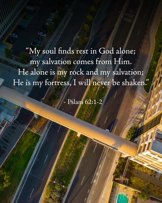 Aerial view of Loma Linda, California where the pedestrian bridge connects the parking structure to the medical center. Overlaid text from Psalm 62:1-2 reads: “My soul finds rest in God alone; my salvation comes from Him. He alone is my rock and my salvation; He is my fortress, I will never be shaken.”