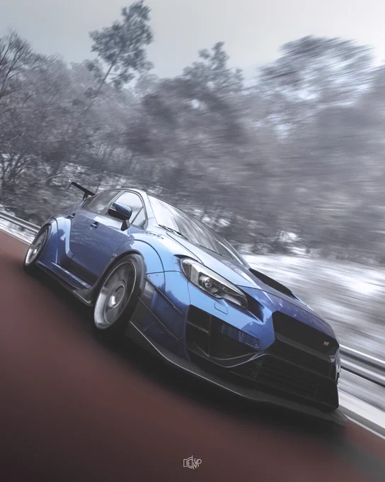 A modified Subaru is driving on a road surrounded by snow-covered trees.