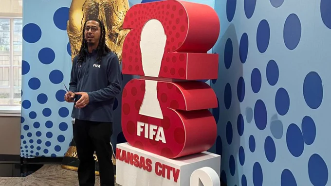 Taylor Ashford in front of a FIFA World Cup 2026 display.