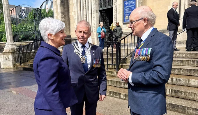 Image of three people - including Junior Minisyer Joanne Bunting - outside St Anne’s Cathedral, Belfast