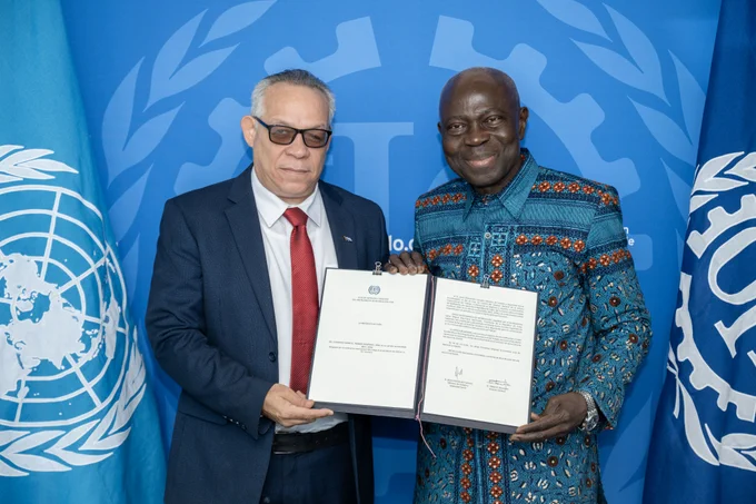 ILO Director-General, Gilbert F. Houngbo, stands next to Jesus Otamendiz Campos, Minister of Labor and Social Security of Cuba, as they hold the documents of ratification. Photo: ILO. 