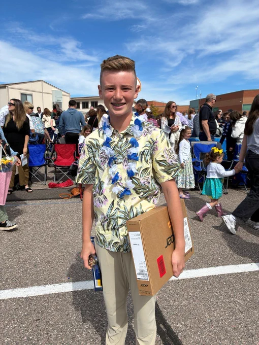 Student holding laptop box