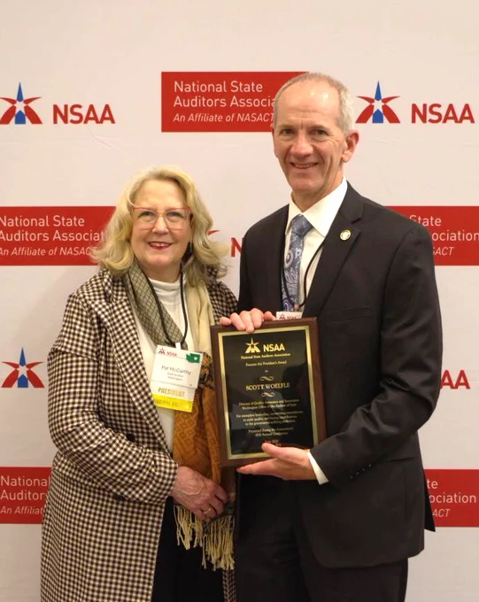 State Auditor Pat McCarthy presenting a plaque to SAO's Scott Woelfle