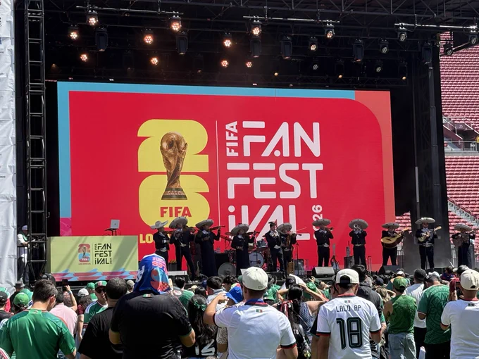 The photo shows the main stage of the FIFA Fan Festival at Expo Park in Los Angeles. The photo shows soccer fans gathering in front of the stage to watch a live performance.