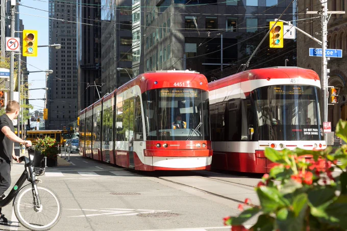 Two TTC Street cars on a road.
