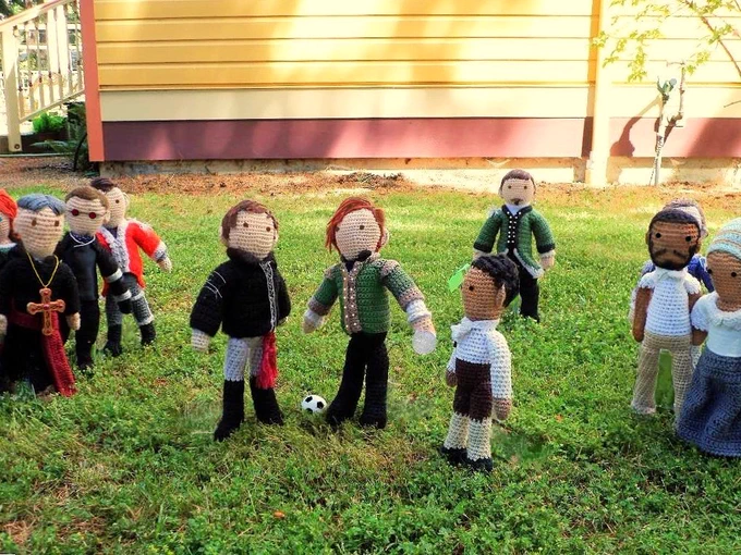 Crochet dolls l-r: Bon Bruciare Gormangia, Vinsher Grath & Adolphus Murtry lined up left with Edmund Hewlett, William Guppy & Cicero centered for the coin toss, while Nicholas Farlow is beyond him and Akinbode & Abigail are on the right. House in background. 