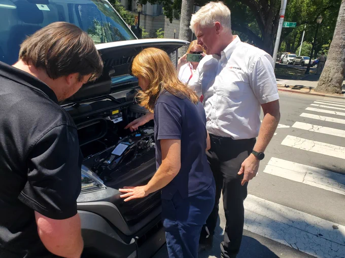 Attendees looking at the engine closely