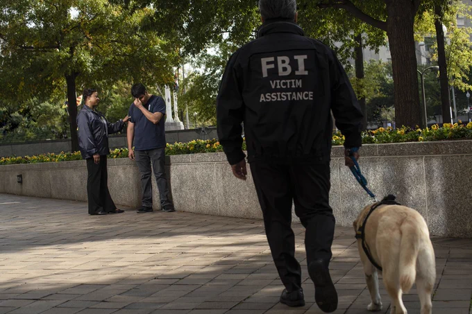 Victim Specialist and Victim Services Division Crisis Response Canine providing support.