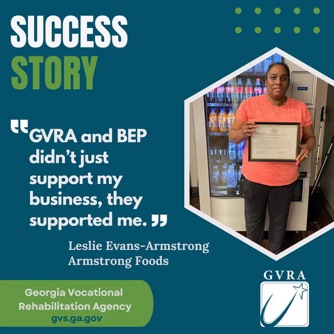 A woman standing behind a vending machine and is holding up a certificate in her hand. 