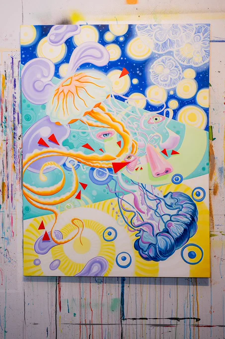 A colorful and surreal abstract painting featuring jellyfish and swirling patterns. The artwork combines vivid colors with whimsical shapes to create an imaginative composition.