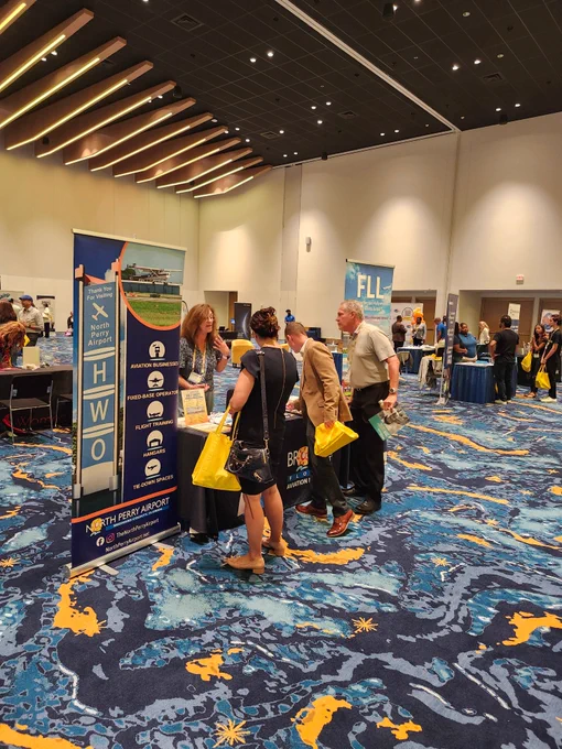 Attendees at the Broward & Beyond Business Conference 2026 visit the airport booth.