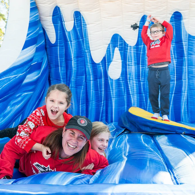 A family enjoys an inflatable attraction during a Stony Brook event.