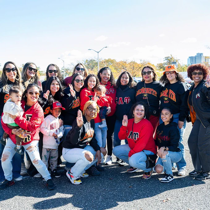 Members of a Stony Brook alumni group pose together outdoors during Homecoming festivities.