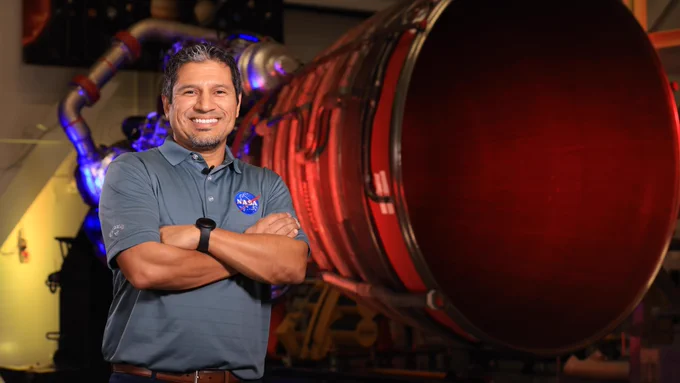 Elkin Norena, who serves as an SLS resident management officer at NASA’s Kennedy Space Center in Florida, stands in front of an RS-25 engine.
NASA