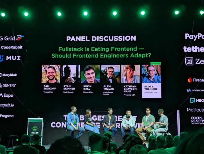 People presenting on stage for a panel discussion