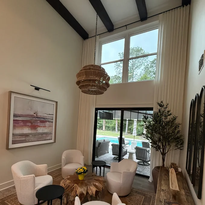 Double-height windows require more than longer panels.

In this installation, full-height drapery unifies the upper transom and lower doors into a single architectural statement—clean vertical lines, controlled stack, and consistent fold from ceiling to floor.

At this scale, fabrication decisions matter. Panel width, pleat spacing, and weight distribution are all calculated to maintain structure across the full drop—ensuring the drapery hangs straight, stacks cleanly, and installs without compromise.
For interior designers, this is where custom fabrication makes the difference: proportion stays intact, the architecture feels intentional, and the installation performs as designed.
