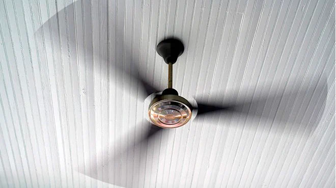 A ceiling fan in motion.