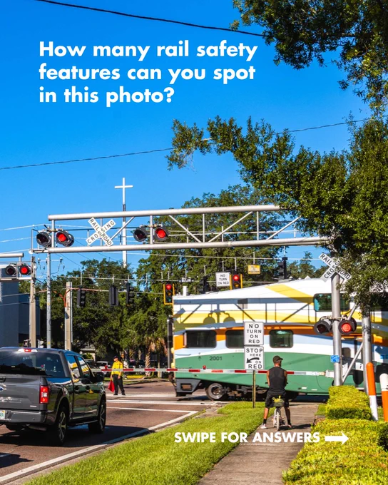 A railroad crossing with multiple safety features, including crossing gates, warning lights, and signage. Text asks how many rail safety features can be spotted.