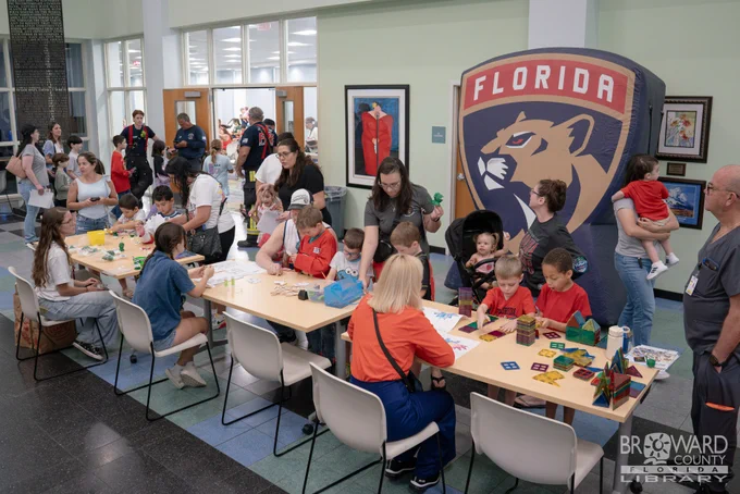A large group in the library lobby enjoying STEAM activities
