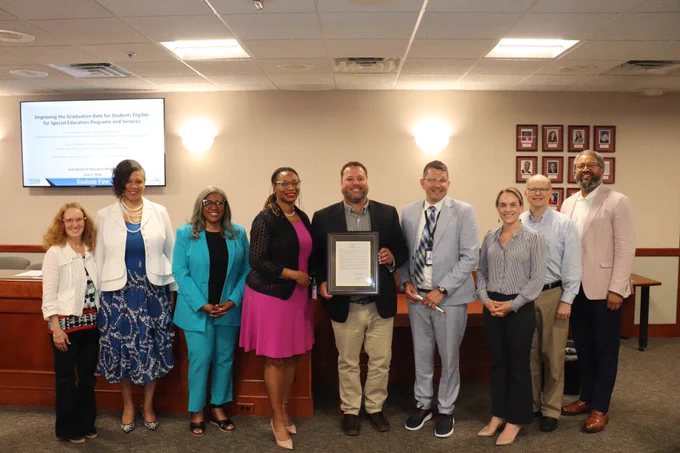 Corey Rosser (center) is recognized for serving as the 2025-26 Michigan Teacher of the Year. 