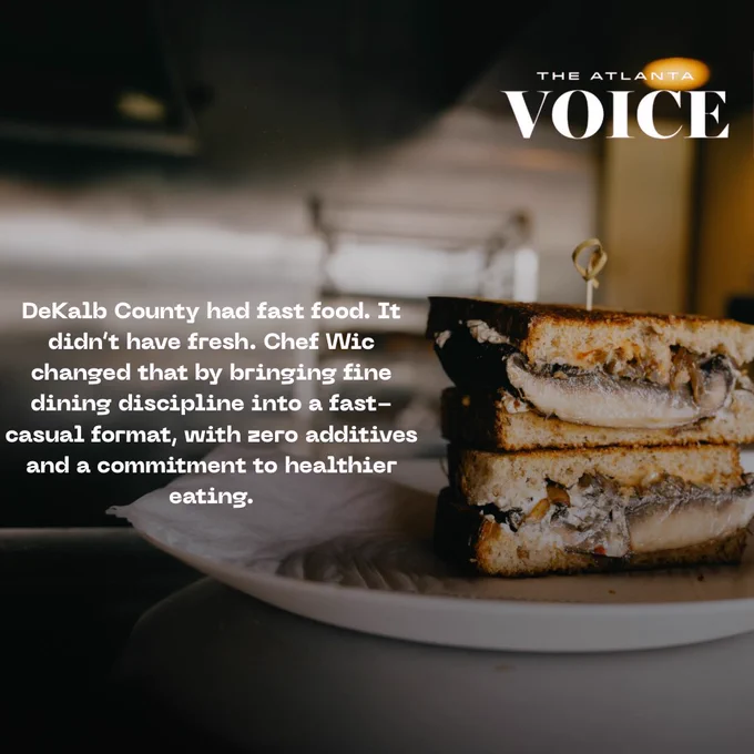 stacked portobello patty melt sandwich on a white plate, shot in a dimly lit restaurant setting.