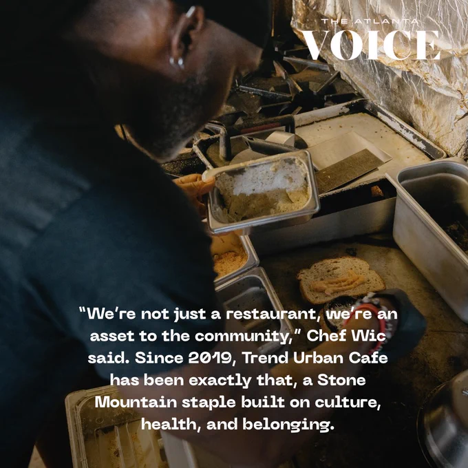 Chef Donnie Wicker works in an open kitchen, focused on plating a dish under the hood of a commercial stove.