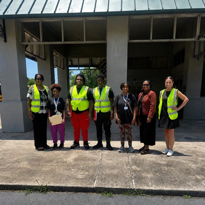 group of seven standing in front of the city of York building
