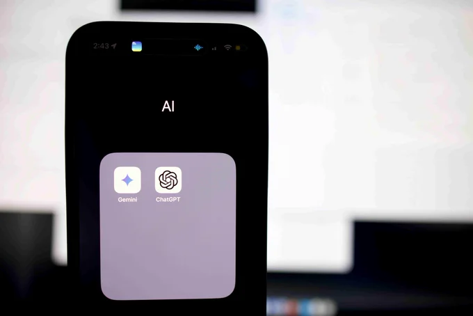 A close up of a cell phone that is displaying a few AI applications.