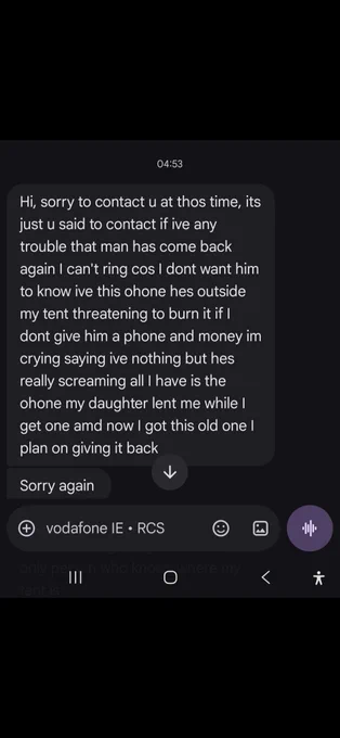 Phone screenshot of a 04:53 text message from a distressed person saying a man has returned outside her tent, is threatening to burn it unless given a phone and money, and that she cannot call because she does not want him to know she has a phone.