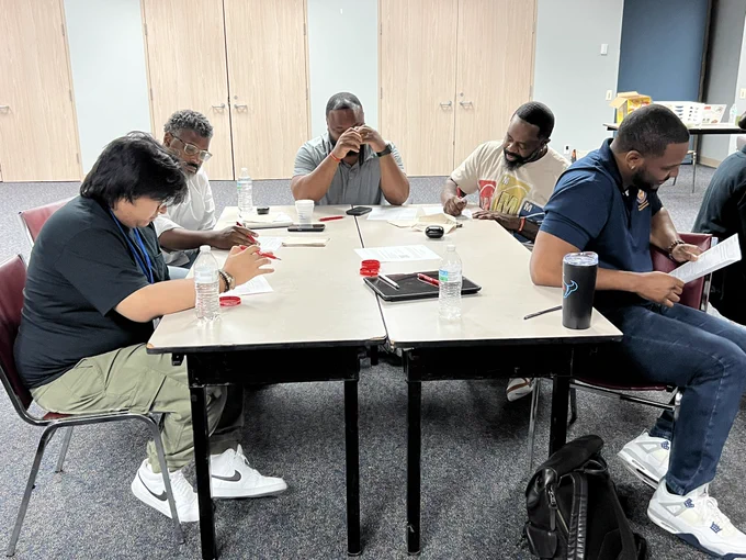 Participants take part in a collaborative emergency preparedness exercise during an American Red Cross shelter operations training. Seated in small groups, attendees review materials, discuss response scenarios, and work through shelter management procedures designed to support residents during emergencies and severe weather events. The training encourages teamwork, problem-solving, and practical decision-making while helping strengthen the Department of Neighborhoods' preparedness efforts through the Houston Emergency Response Team (HERT) program. Through exercises like these, participants gain valuable knowledge and skills to better serve and support Houstonians during times of crisis.