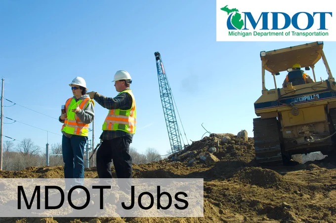 Two workers in safety gear at a jobsite.