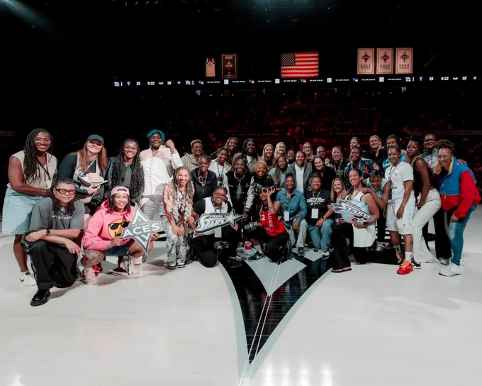 Dallas College Mountain View Athletic Director and former WNBA player Keitha Dickerson (back row, fifth from left) was honored by the Las Vegas Aces as part of the league's 30-year anniversary. 